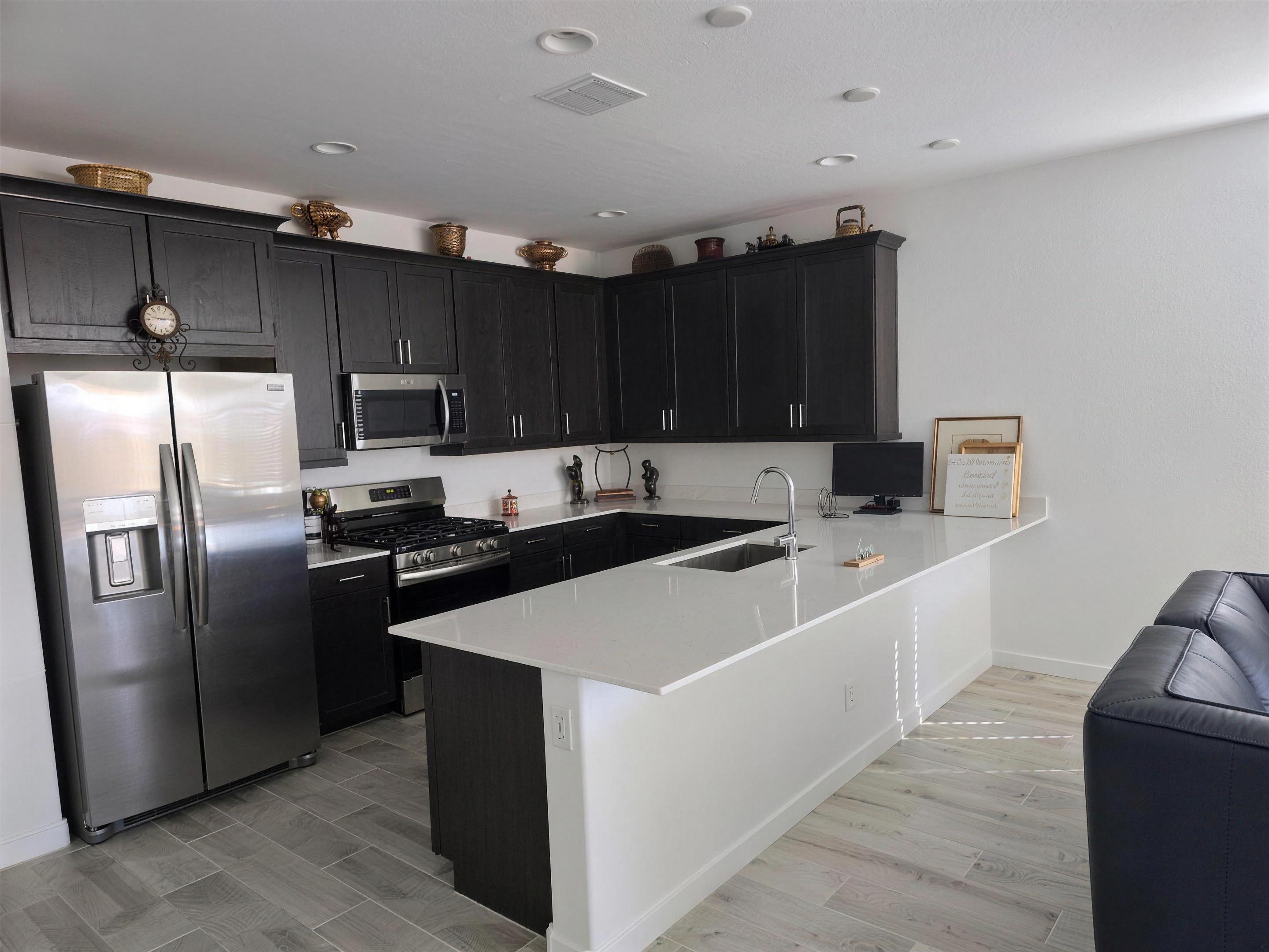 Chef kitchen with island inside The Greenwood furnished rental